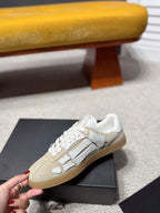 Amiri cream low-top sneakers with gray logo stripe, side view, gum sole