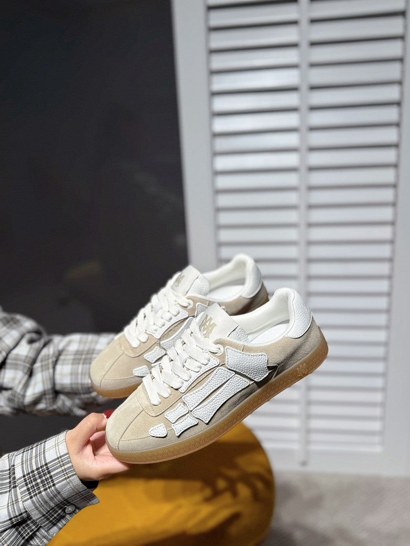Amiri lace-up sneakers with cream uppers and gray logo trim, gum sole