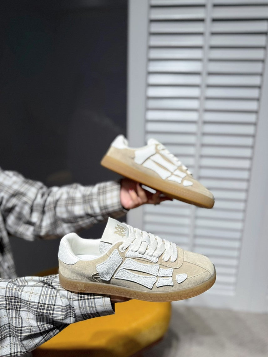 Amiri cream lace-up sneakers with gray logo details and gum outsole