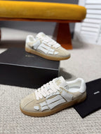 Amiri cream and gray logo sneakers on the floor, gum sole, lace-up