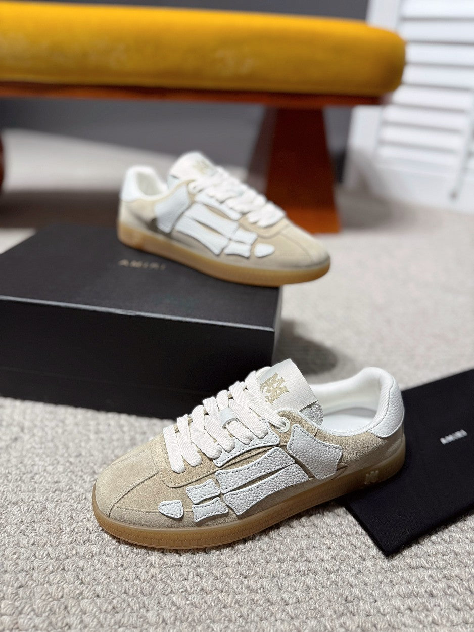 Amiri cream and gray logo sneakers on the floor, gum sole, lace-up