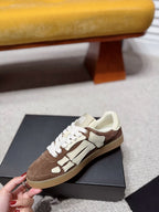 Suede sneakers on black box, brown and cream with white laces and logo