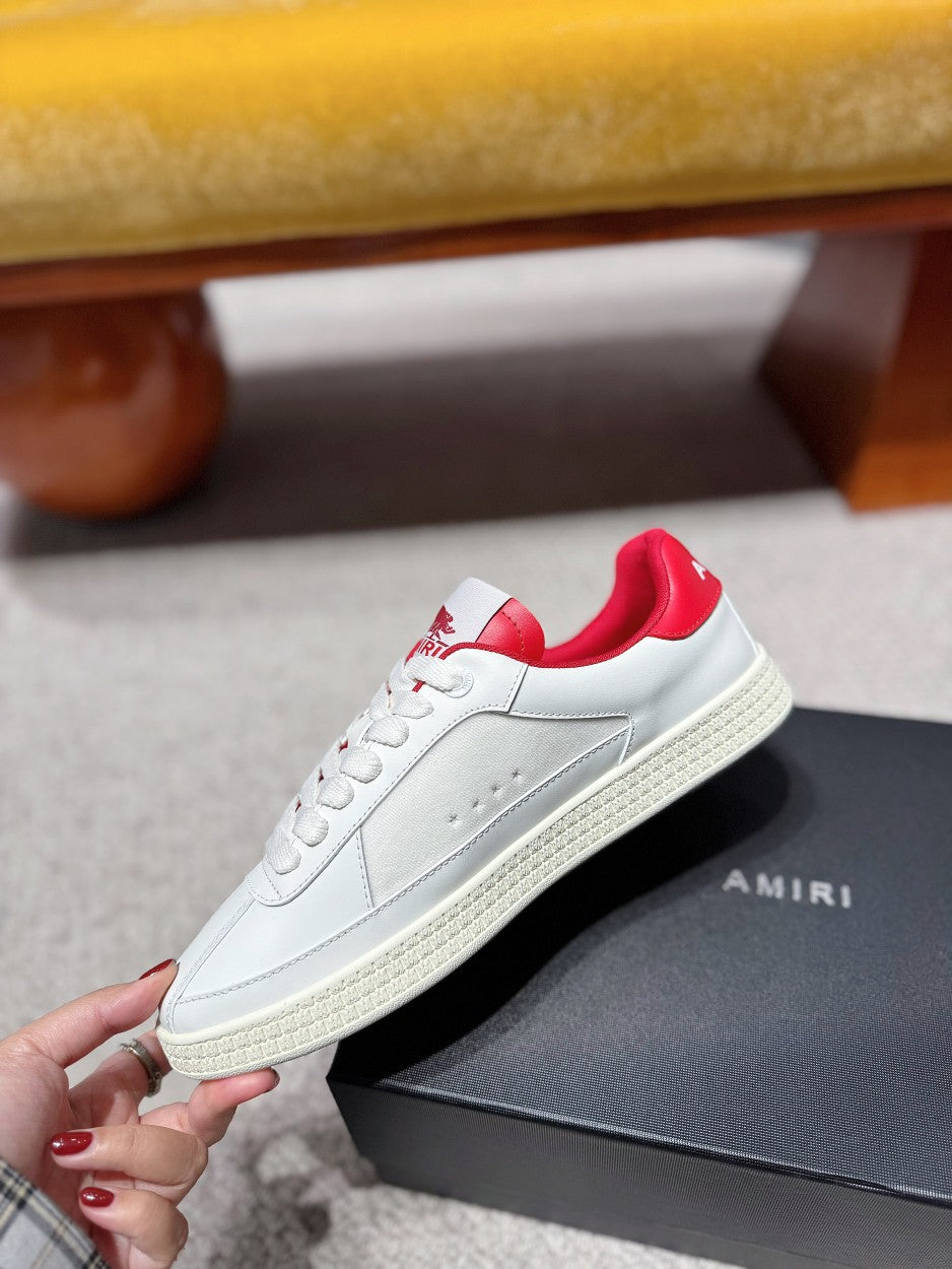 White low-top sneakers with red heel lining and red star side graphics on box
