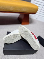 White sneaker outsole view with tread and red star side detail