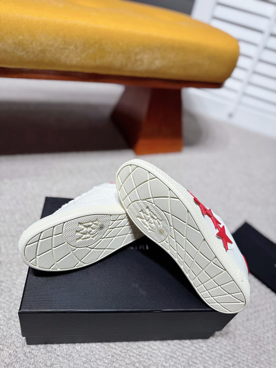 White sneaker outsole view with tread and red star side detail
