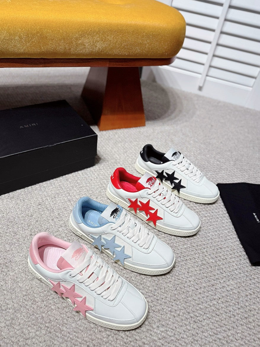 Multiple colorway sneakers: white with red, blue, and pink star appliques