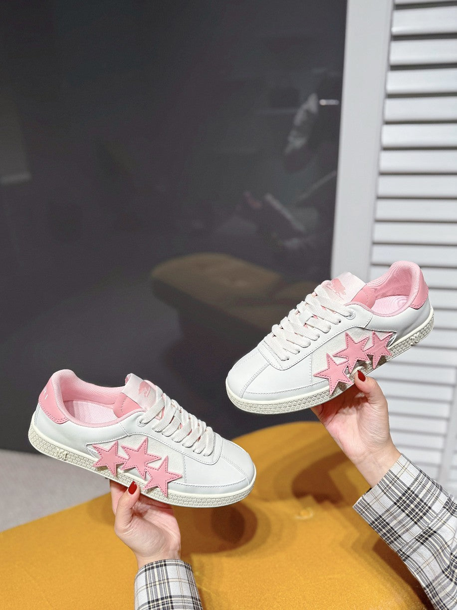 White sneakers with pink star logo patch on side and pink collar lining