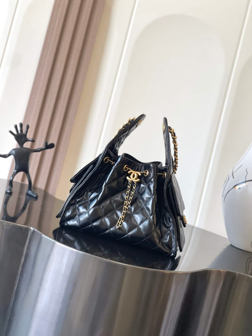 Chanel quilted black leather shoulder bag with gold chain handle and tassel
