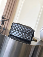 Chanel quilted black leather flap bag with gold chain shoulder strap