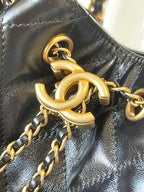 Chanel gold chain links and leather hardware on black leather bag