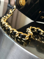 Chanel bag with gold-tone chain strap and black leather edge detail