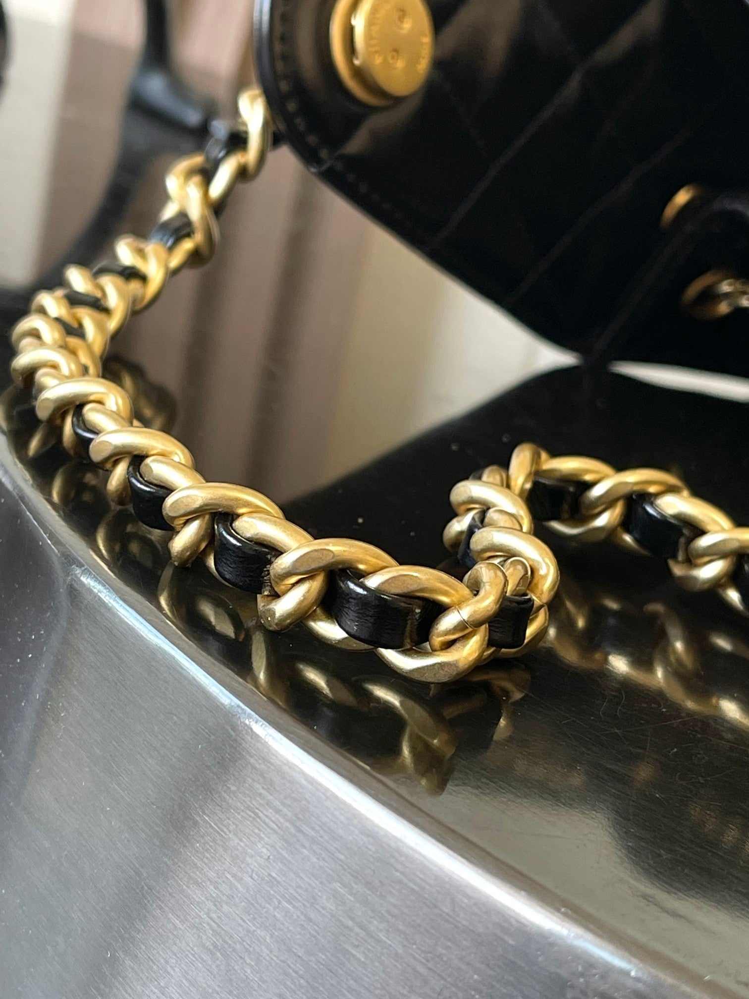 Chanel bag with gold-tone chain strap and black leather edge detail