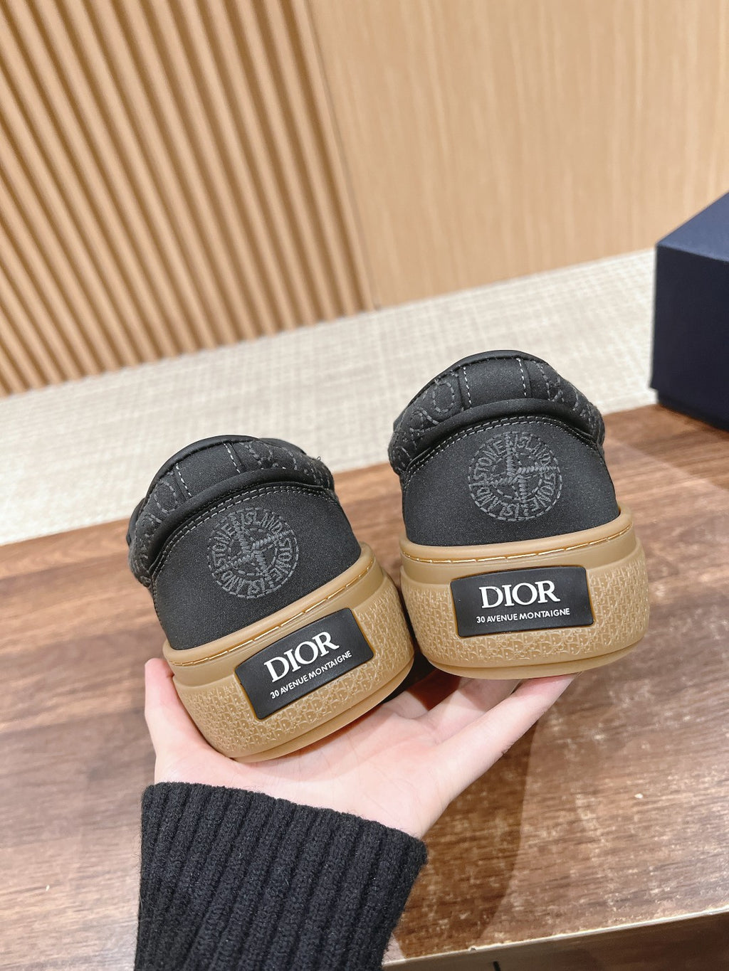 Black low-top sneakers rear view with Dior logo on beige heel tabs