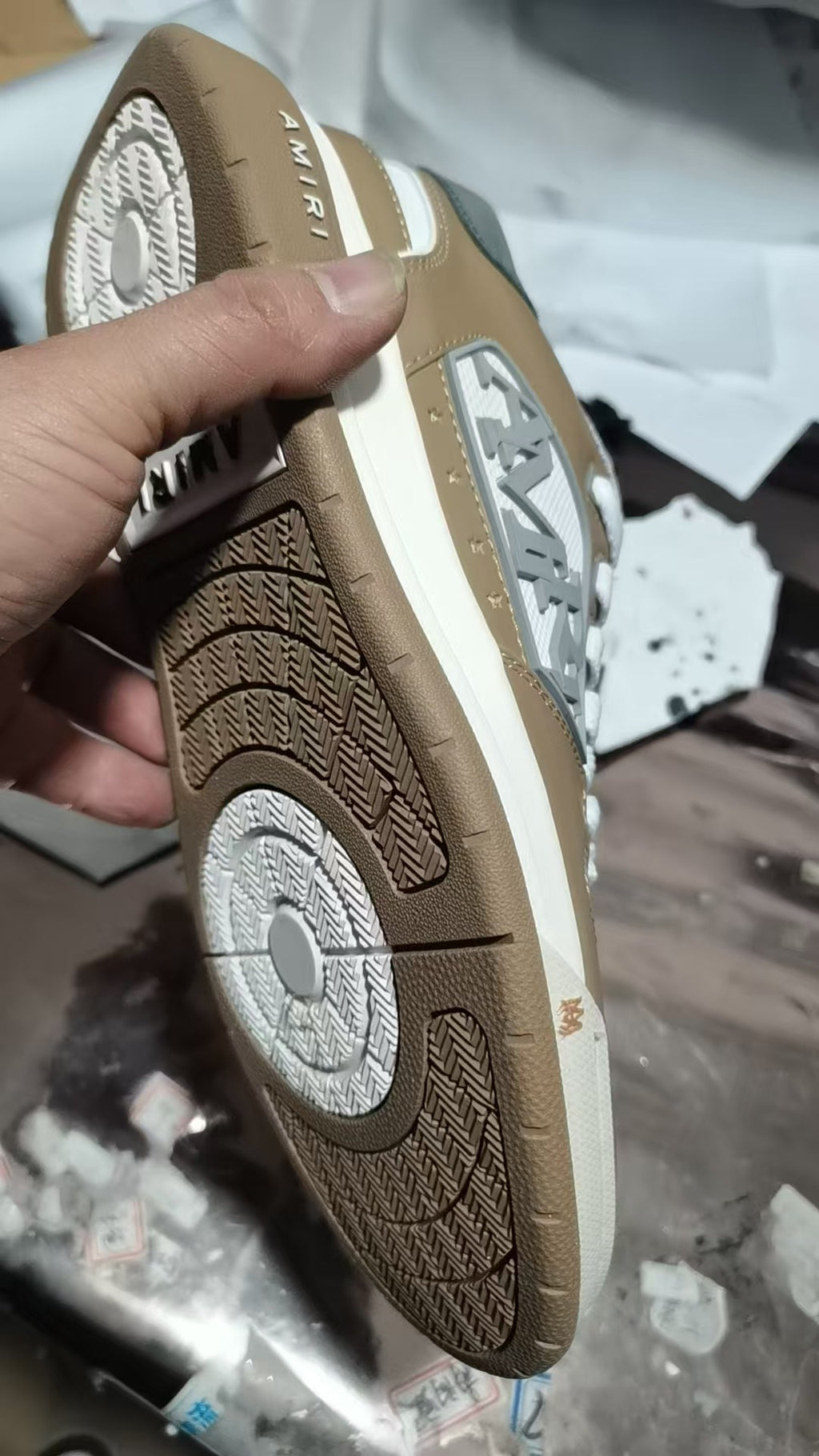 Brown sneaker outsole with circular logo and patterned tread