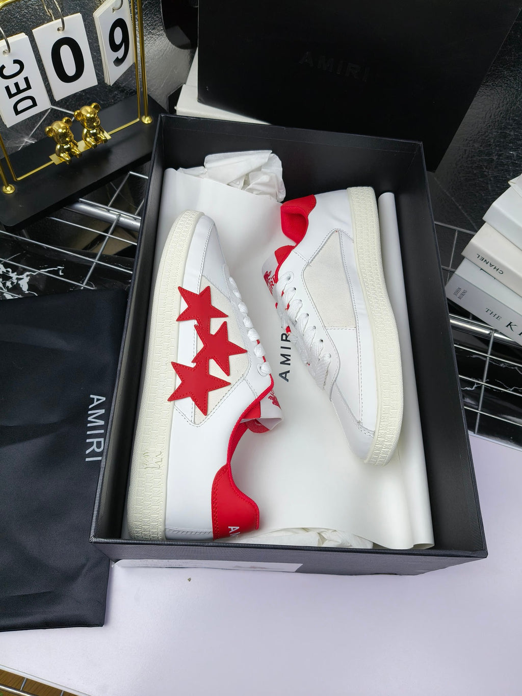 Low-top sneakers in box, white with red star side panels and white lace-up uppers
