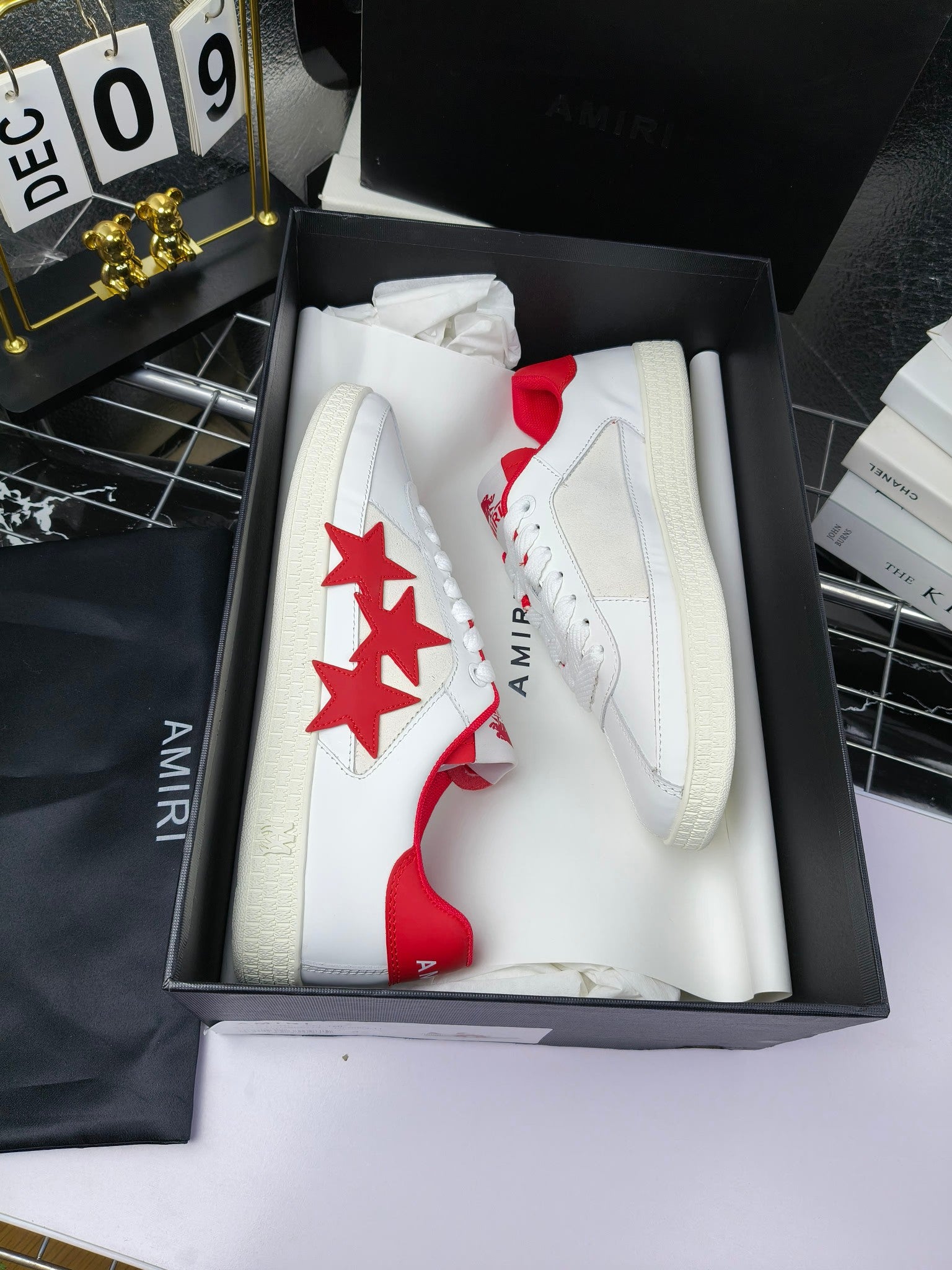 Low-top sneakers in box, white with red star side panels and white lace-up uppers