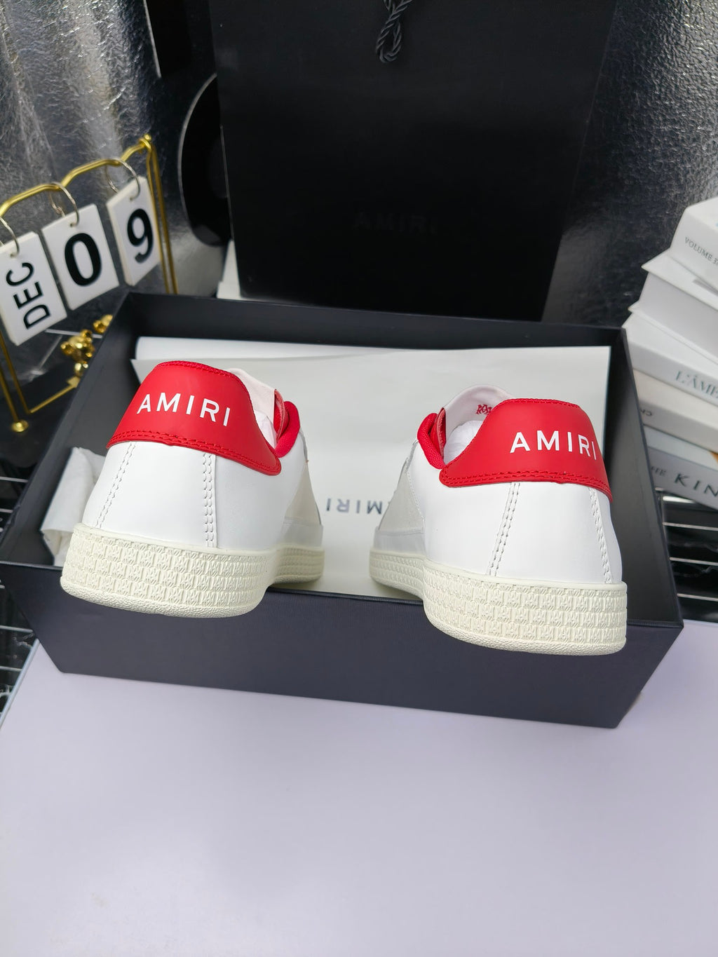 Pair of low-top sneakers showing heel branding, white uppers with red collar lining