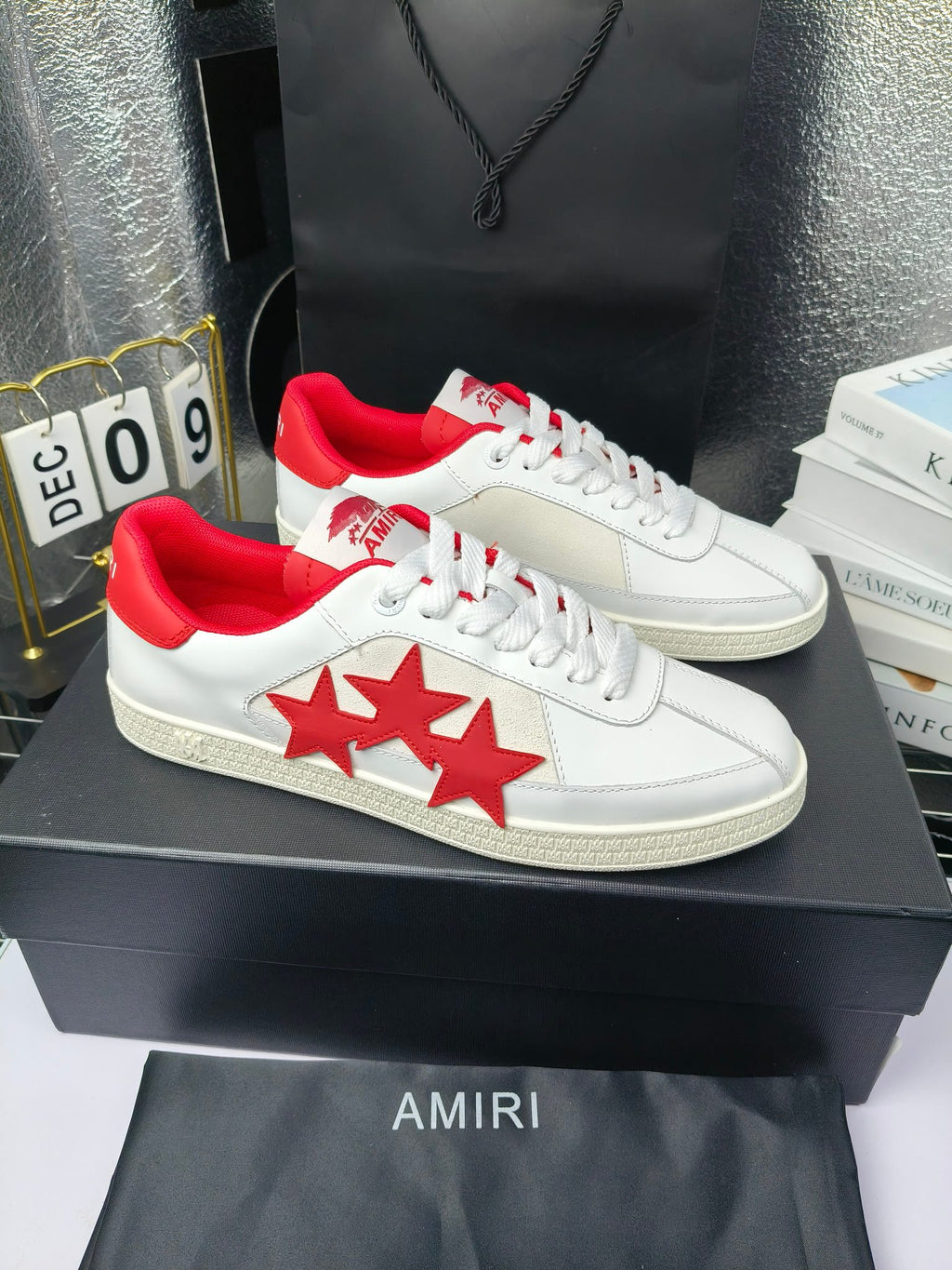 Pair of low-top sneakers, white leather with red star panels and red heel accents