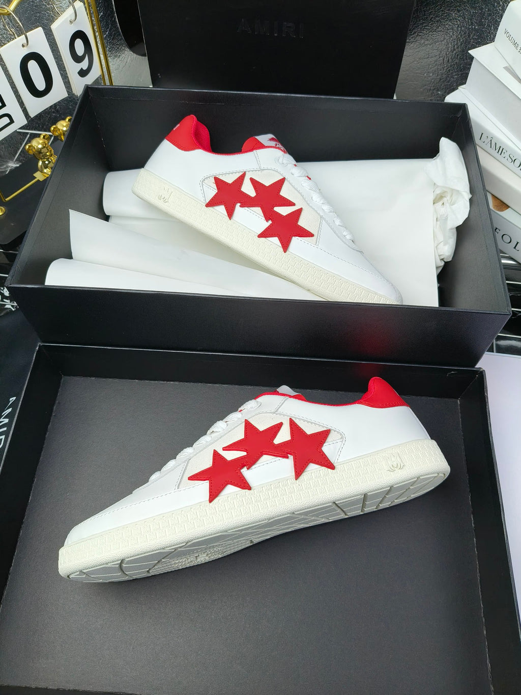 Low-top sneakers in stacked boxes, white with red star graphic on side