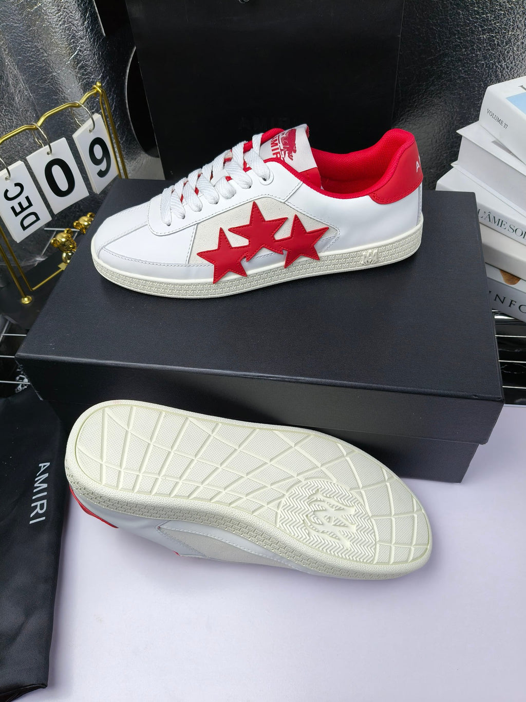 White low-top sneakers with red star patch, red heel lining and textured rubber sole