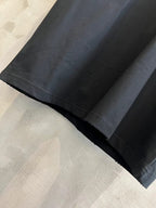 Short-sleeve T-shirt hem detail, dark fabric with stitched edge