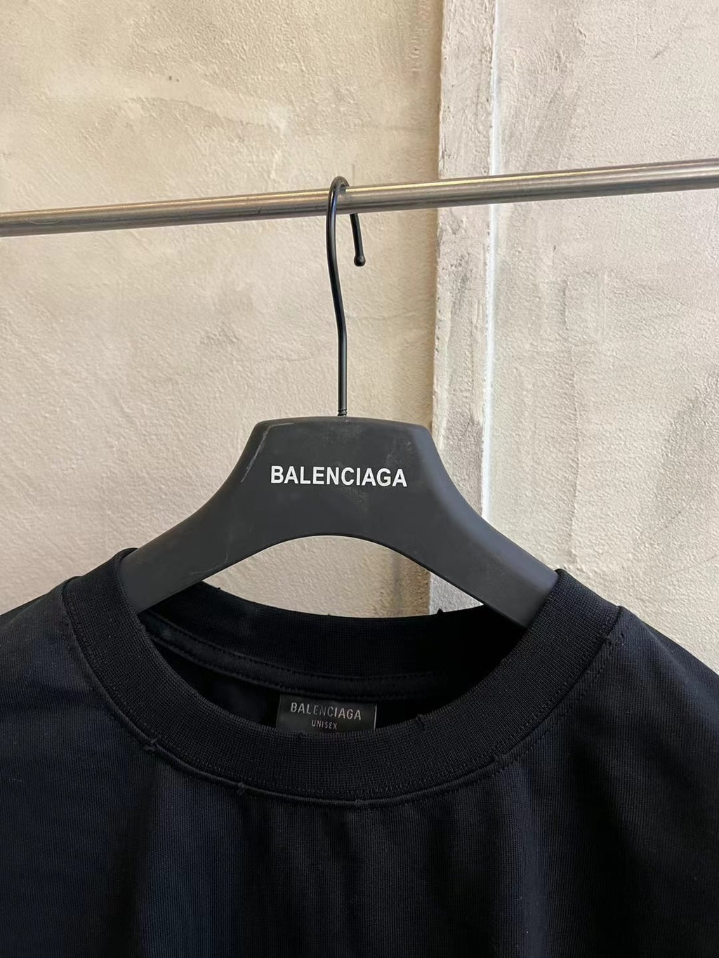 Black crew-neck T-shirt close-up at collar with Balenciaga label