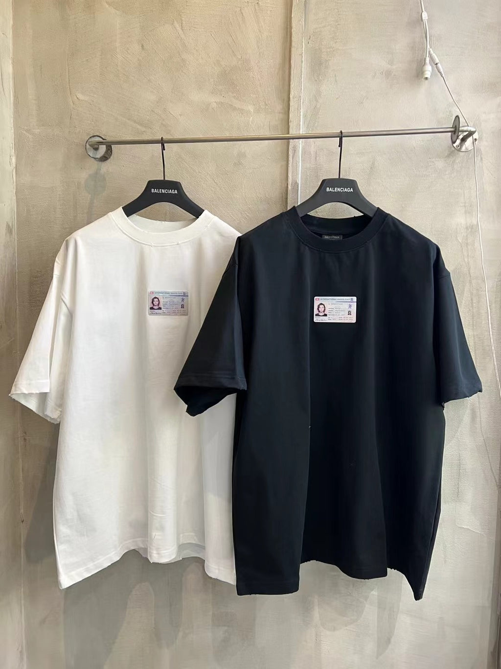 Pair of short-sleeve T-shirts: white and black, each with chest label