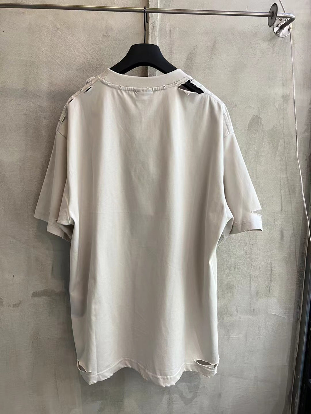 White Balenciaga graphic T-shirt back view on a hanger