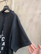 Balenciaga black T-shirt with short sleeves and partial front logo lettering