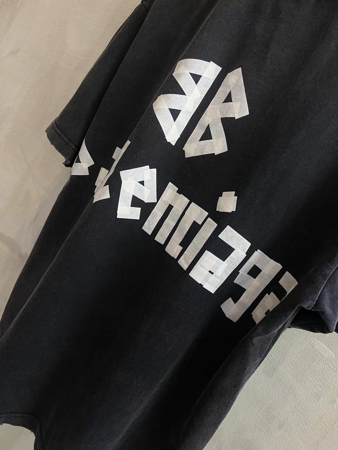 Black T-shirt with white BALENCIAGA logo graphic across front