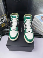 Green and white high-top sneakers with black accents and white laces, cream sole.