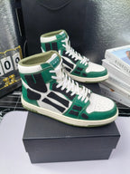 Green and white high-top lace-up sneakers with black logo-style panels, cream sole.