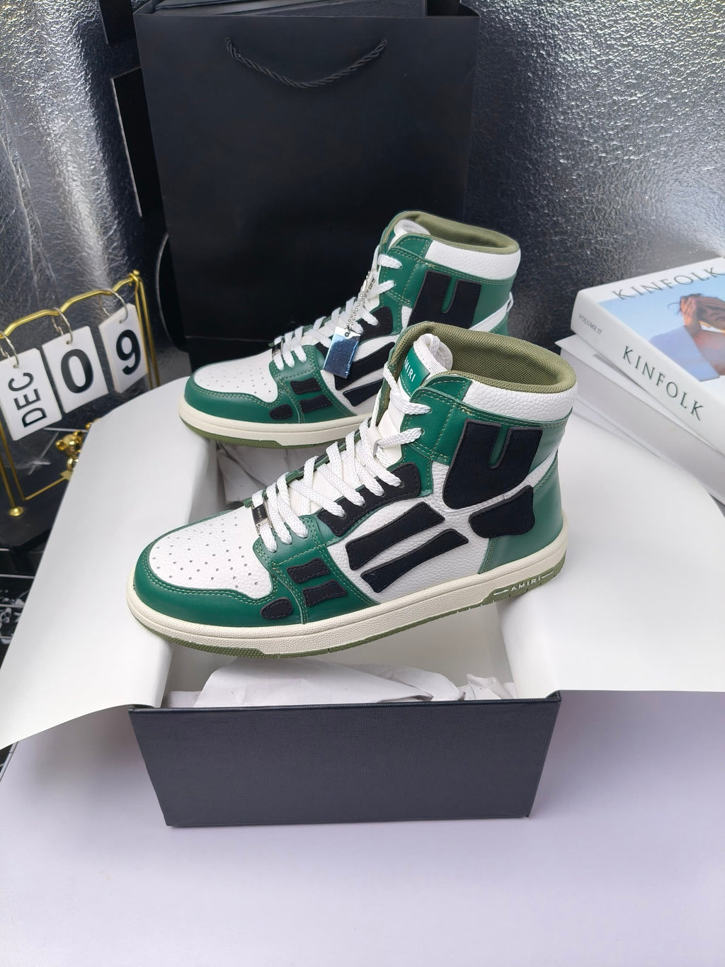 Green and white high-top lace-up sneakers with black panels and white laces, cream sole.