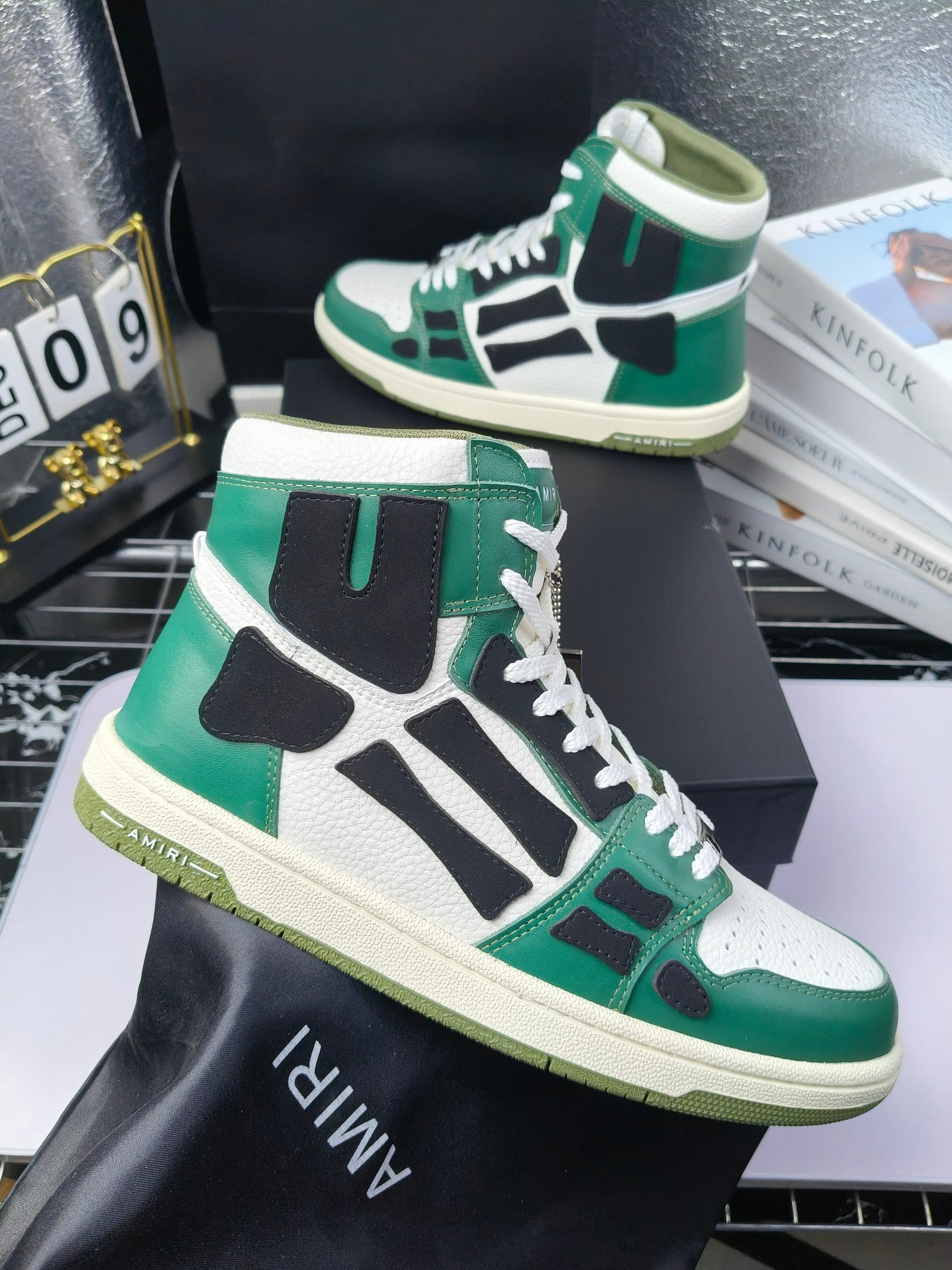 Green, white, and black high-top lace-up sneakers with textured cream sole.