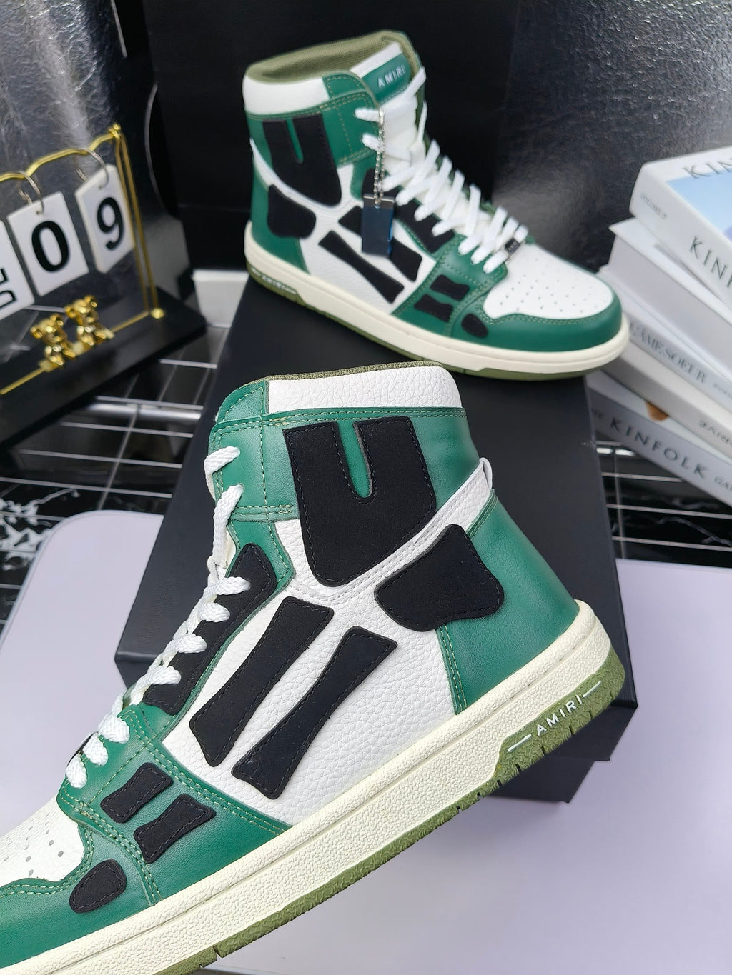 Green and white high-top lace-up sneakers with black panels and white laces, cream sole.