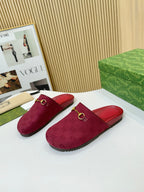 Gucci mule sandals, dark red GG-patterned fabric with gold buckle detail on the vamp