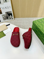 Gucci red mule sandals with GG logo texture and gold-tone horsebit-style buckle trim