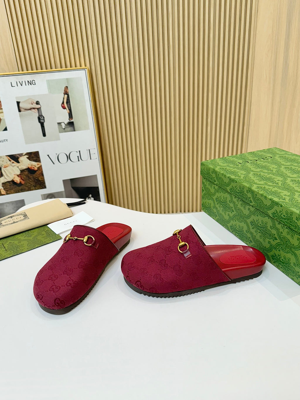 Gucci mule sandals with dark red textured uppers, GG pattern, and gold-tone buckle strap