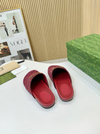 Gucci mule sandals with dark red GG-patterned uppers and visible interior lining