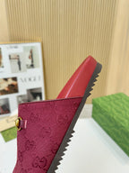 Gucci mule sandal in dark red with GG pattern and gold buckle; visible textured side sole