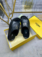 Fendi black leather slide sandals with gold logo buckle and cushioned footbed