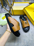 Fendi leather sandals in tan with black soles and gold buckle detail.
