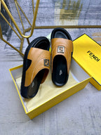 Fendi sandals on box insert, tan leather with black soles and square gold buckle.