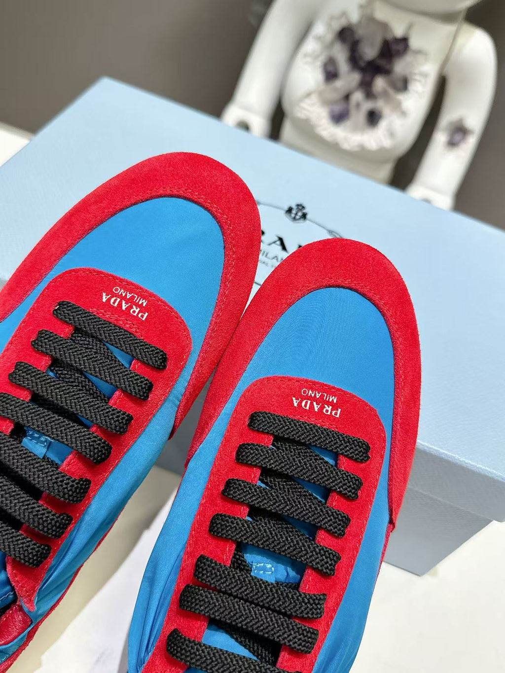 Prada unisex sneaker insoles, red lining and black lace eyelets visible