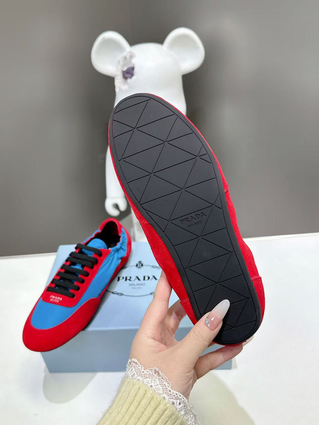 Prada unisex sneakers outsole view, red tread with geometric pattern