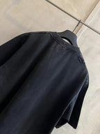 Black short-sleeve T-shirt back/upper view with curved yoke seam and collar