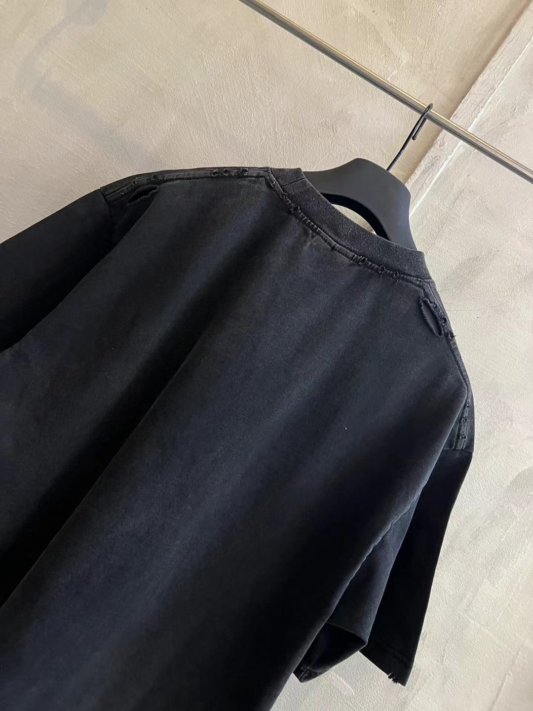 Black short-sleeve T-shirt back/upper view with curved yoke seam and collar