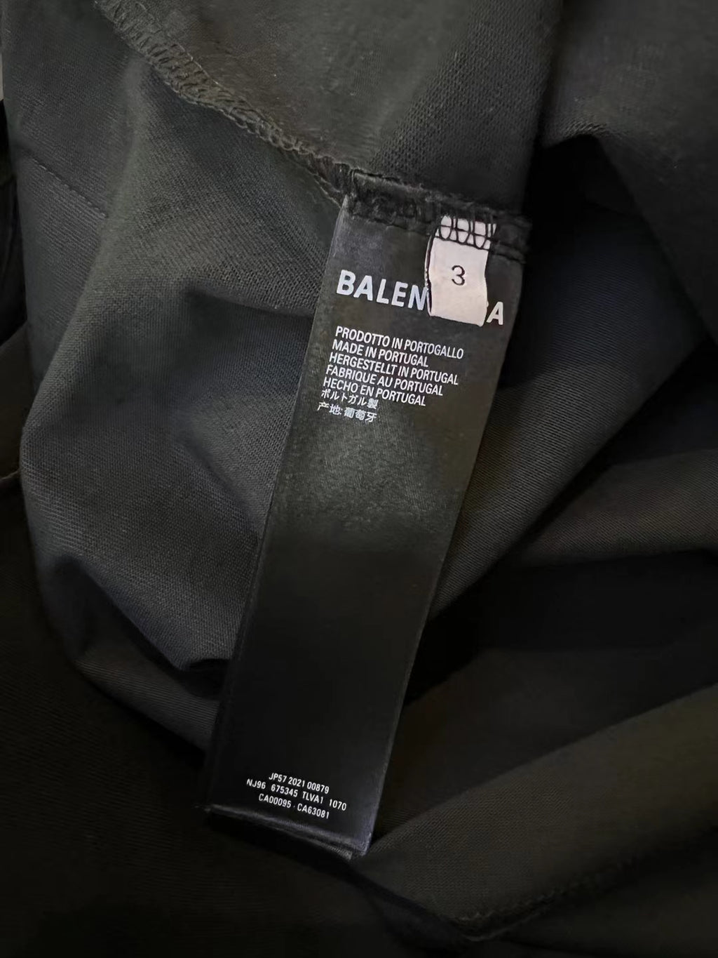 Balenciaga T-shirt care label on dark navy fabric