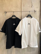 White and black short-sleeve T-shirts on hangers with logo