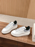 Pair of white leather sneakers with black lining and rubber soles